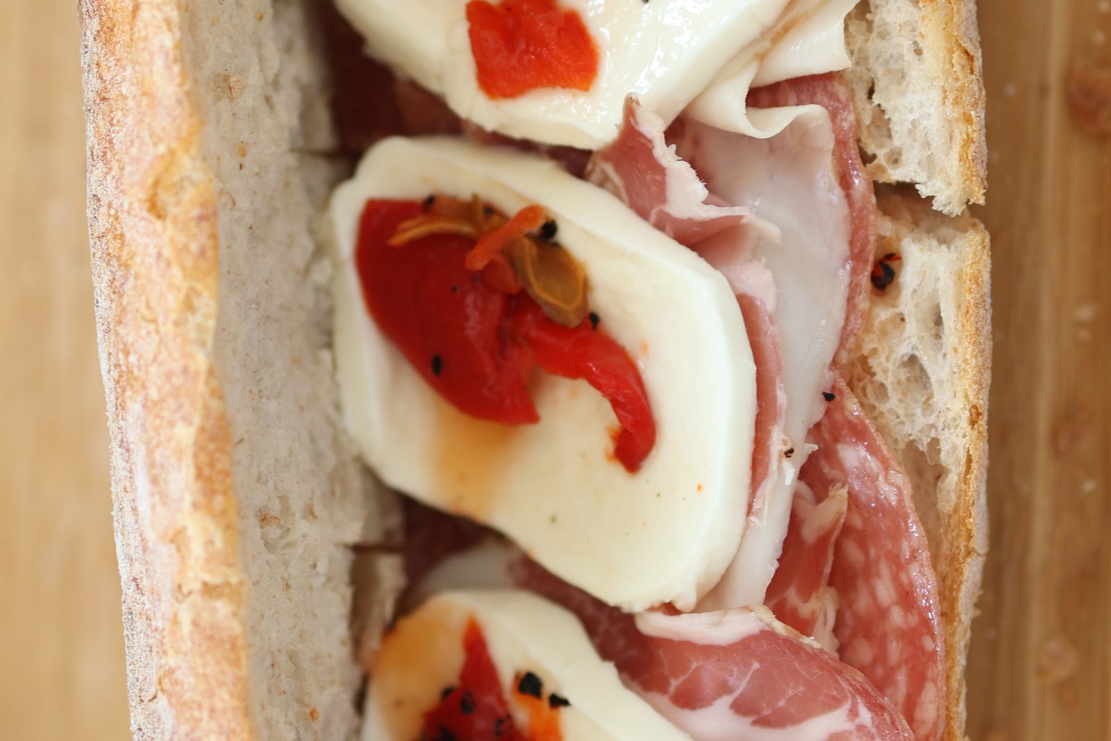 the Italian hero in cross-section — capicola, mozzarella, roasted peppers
